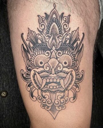 Detailed Barong tattoo on a person's arm, showcasing intricate linework and shading. A striking example of Balinese art. Created by expert tattoo artists in Bali.